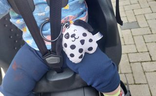 Child in child seat with toy attached