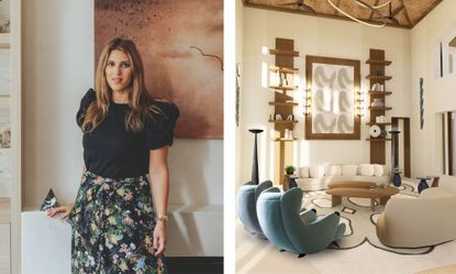 A high-ceilinged, contemporary living room designed by Lucy Goldbart featuring a neutral color palette with wood accents. Two curved cream sofas and two teal scalloped armchairs surround organic-shaped wooden coffee tables on a large patterned rug. The focal point is a large abstract wall hanging flanked by symmetrical wooden shelving units and tall, slender floor lamps.