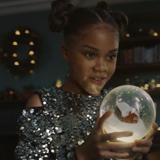 A still shot from the M&S Christmas ad 2024 of Skylar holding a snow globe