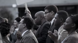Aaron Pierre as Malcolm X in a crowd in Genius: MLK/X episode 6