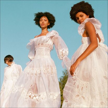 three women in white linen dresses