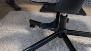 A closeup shot of the height adjustment knob on the ProtoArc EC100 office chair