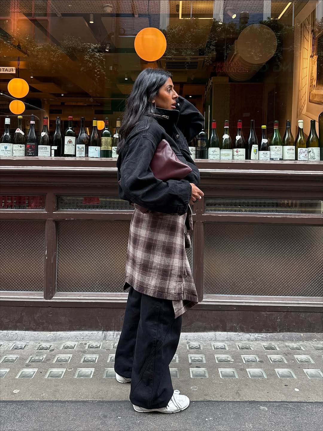 @monikh wears flannel shirt and black trousers and jacket