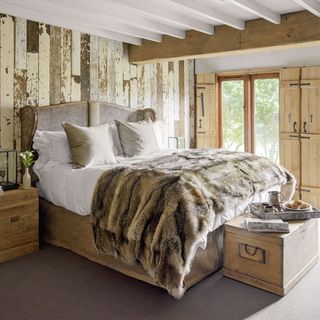 bedroom with wooden window and bed