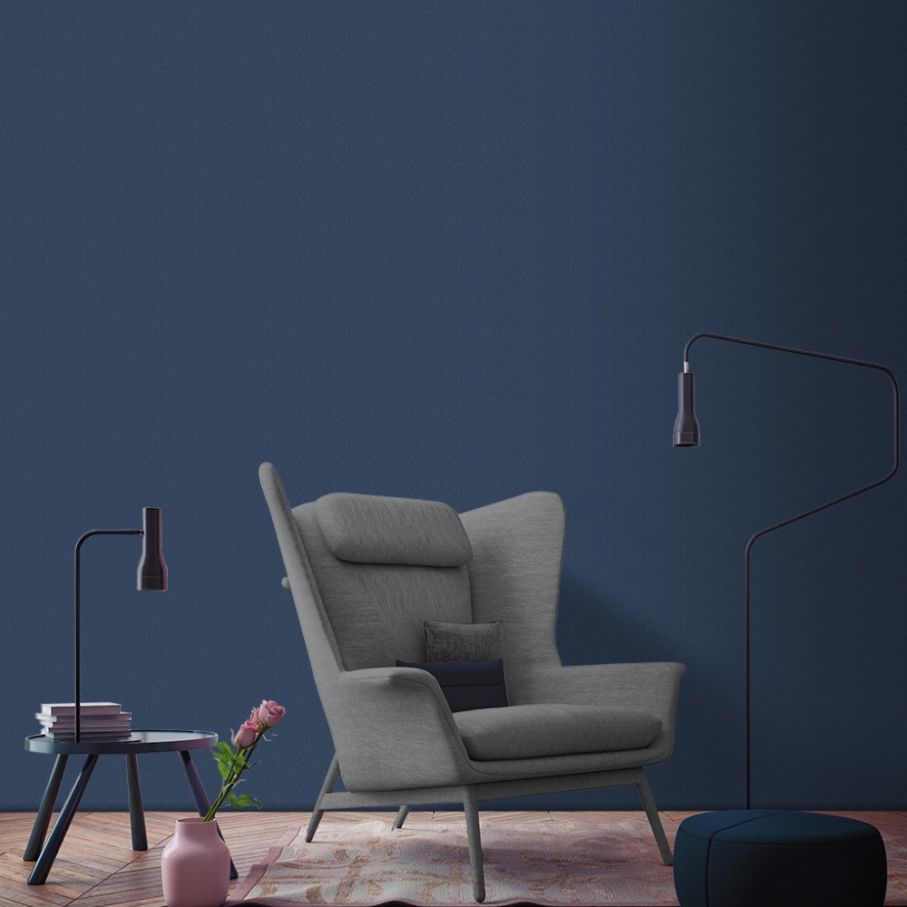 room with blue wall and grey arm chair and wooden floor and side table