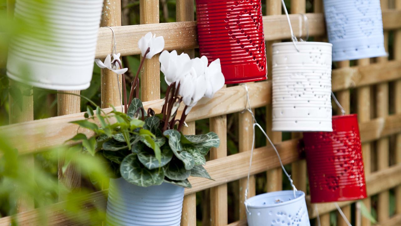 Closeup of handmade planters made from tin cans.