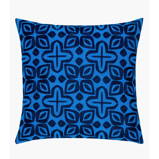 blue pillow with black embroidered pattern