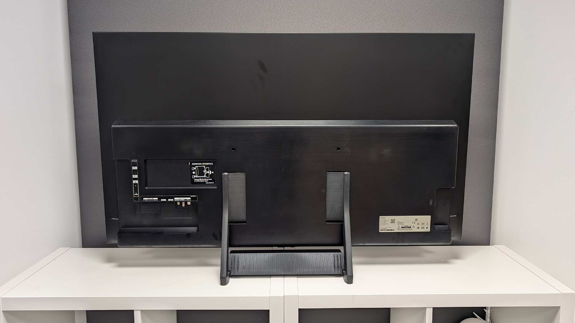 Samsung S90F 48-inch OLED TV, rear view of set on white wooden furniture