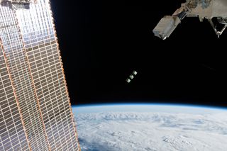 The three Cubesats being ejected from the ISS