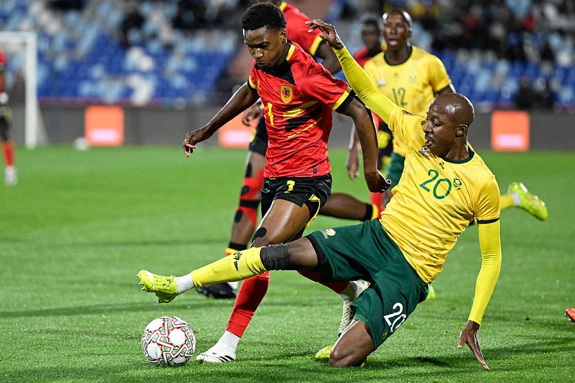 South Africa's defender #20 Khuliso Mudau (R) fights for the ball with Angola's forward #07 Felicio Milson (C) during the Africa Cup of Nations (CAN) Group B football match between South Africa and Angola at Marrakesh Stadium in Marrakesh, Morocco on December 22, 2025. (Photo by Khaled DESOUKI / AFP)