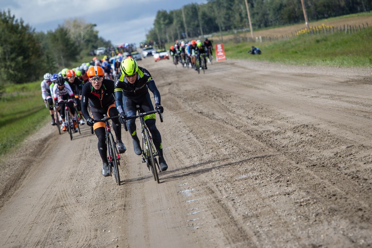 The peloton divides to avoid mud lagoon on the stage 3 route in Alberta