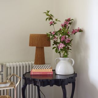 small black table with display items and flowers