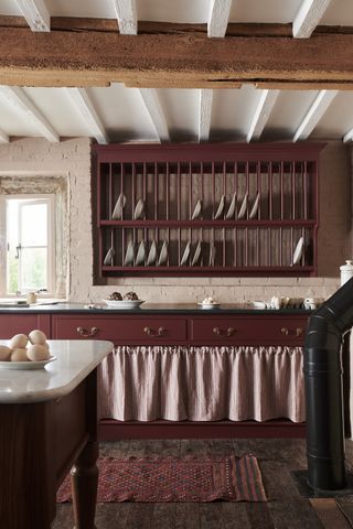 heirloom kitchen burgundy with painted cabinetry and plate rack