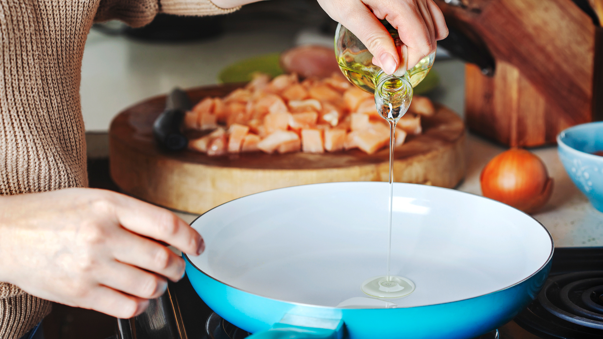 woman pouring cooking oil into a pan