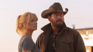 Beth and Rip standing together outside in the sunlight in Dutton Ranch Season 1