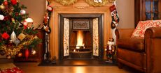 Decorated fireplace in a family home with Christmas tree