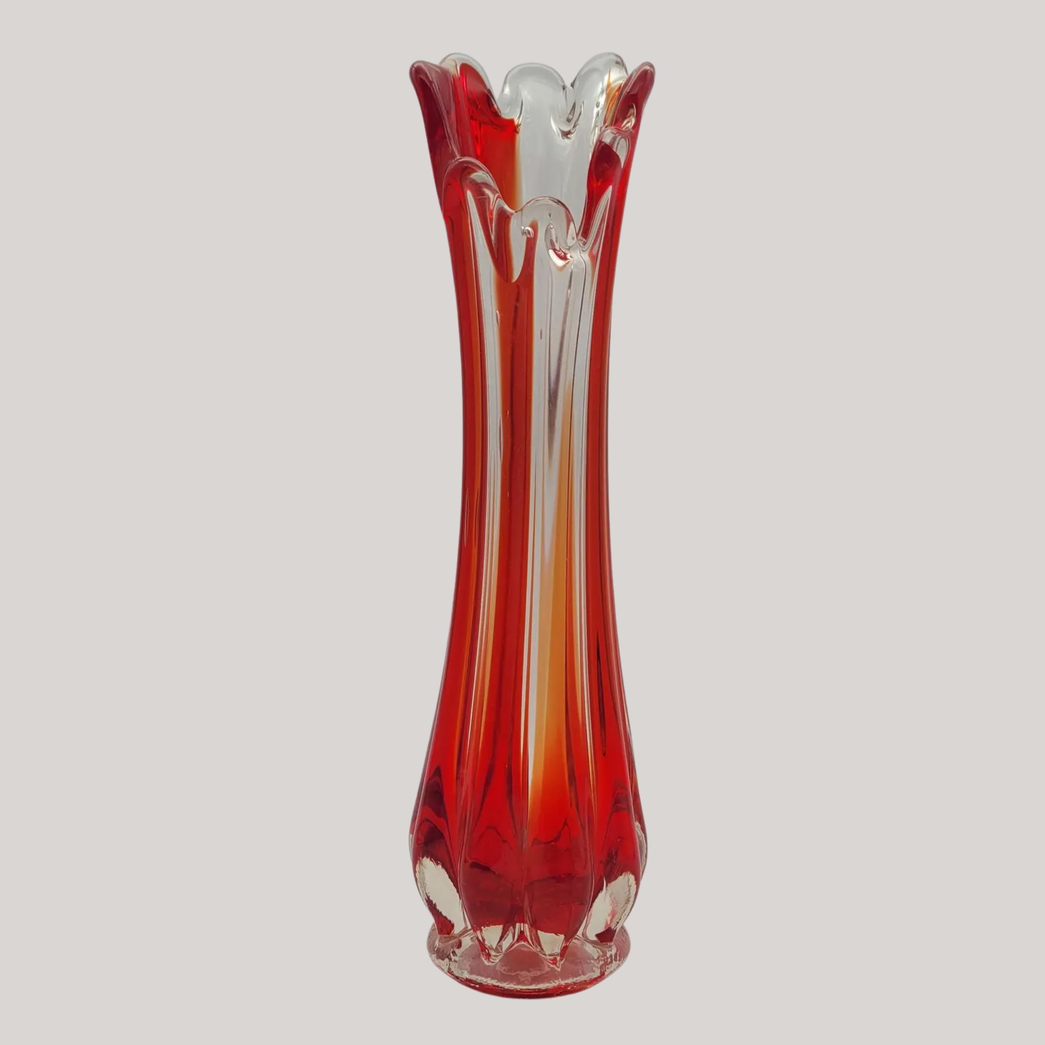 Oldnog A Tall Mid-Century Swung Glass Vase in Red, Amber &amp;amp; Clear against pale brown background.