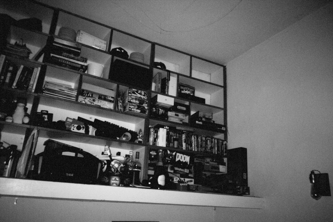 Grainy black and white photo of bookshelves at a house party during Christmas taken with the Flashback ONE35 redisposable digital camera
