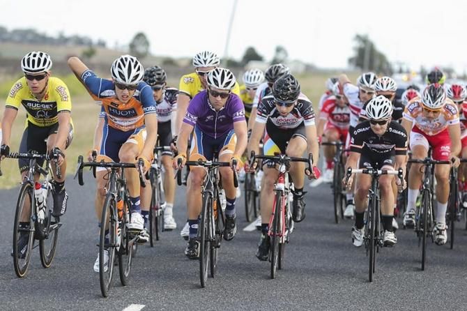 Nathan Earle (Huon-Genesys) in purple sits protected at the front of the bunch