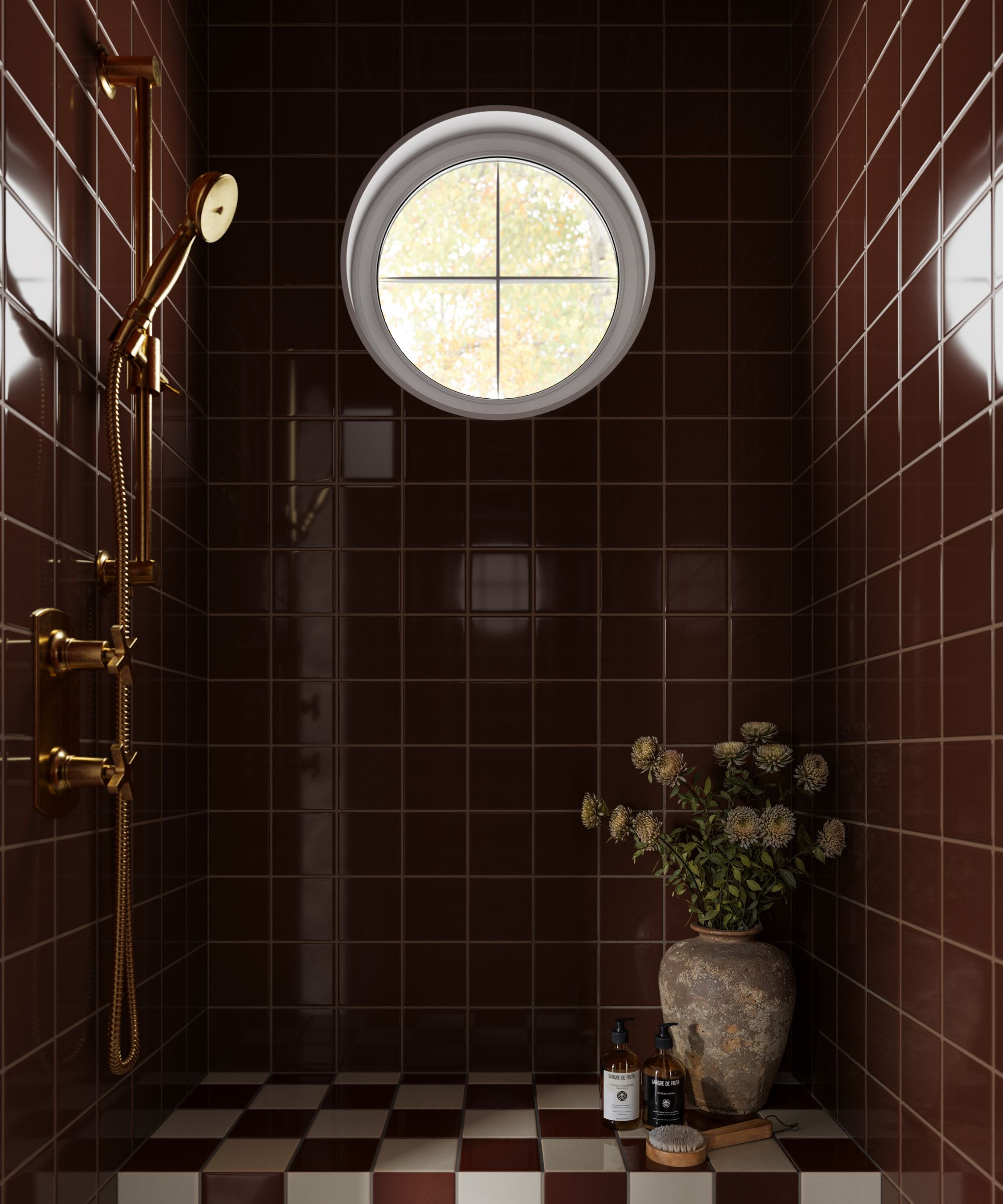 A shower nook decorated with dark brown-red tiles and brass hardware