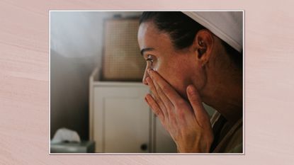 Image showing a side view of a woman cleansing her face, set in a white frame against a dusky pink watercolour-style background