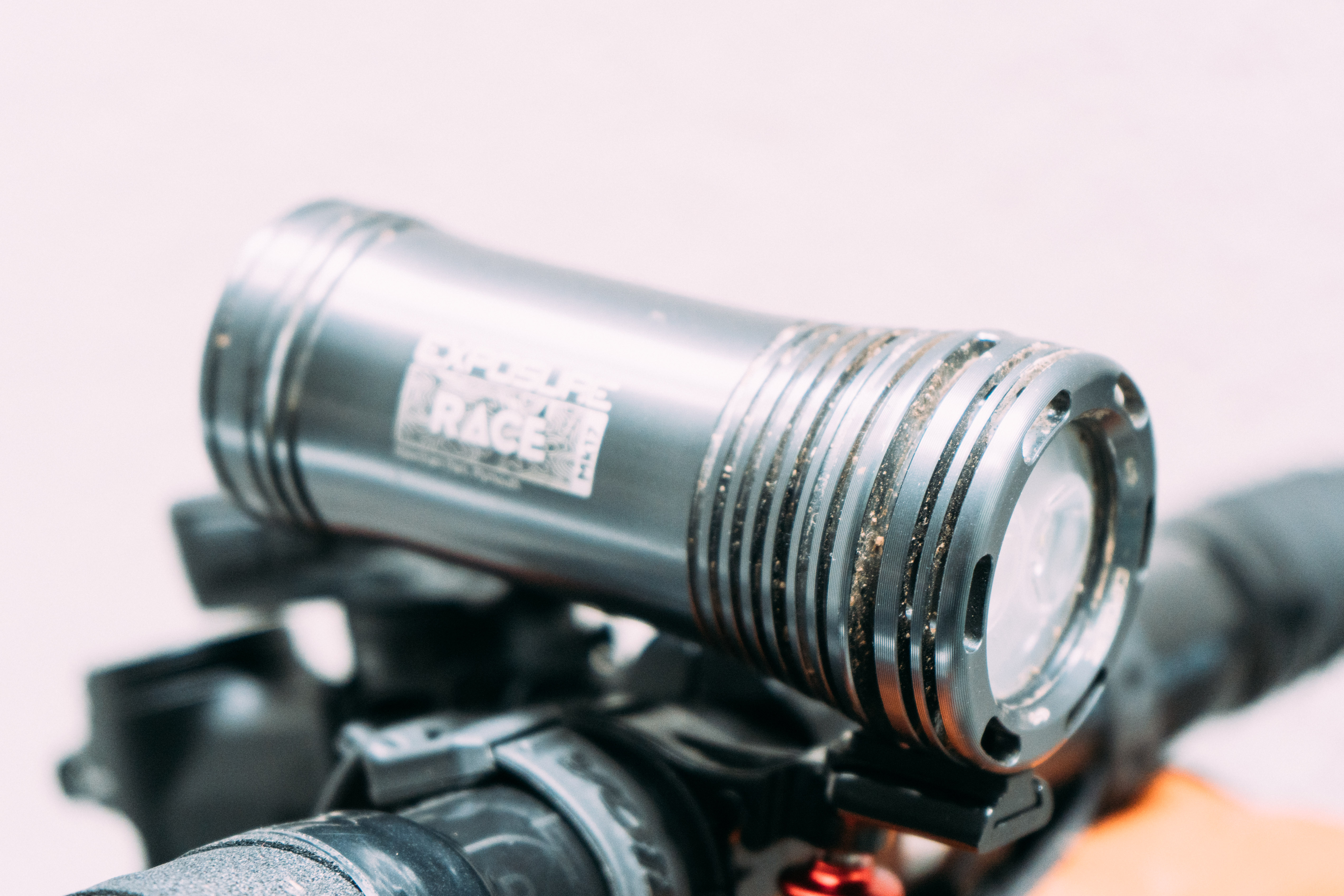 A 3/4 view of a gunmetal grey cylindrical bike light