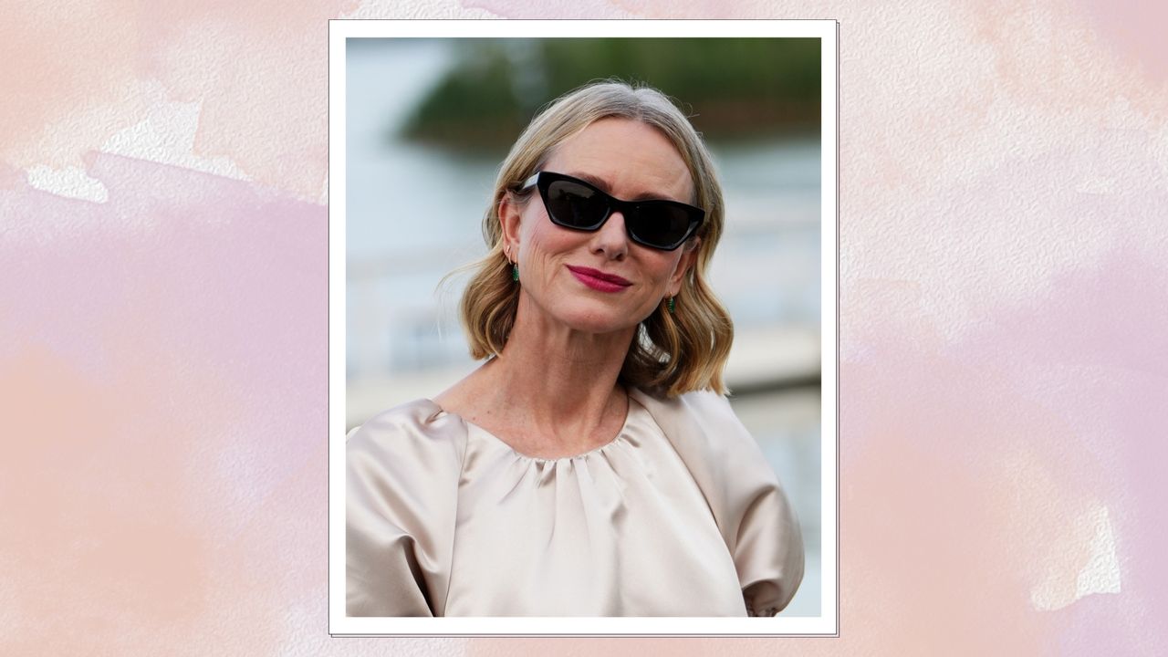 Naomi Watts is pictured with a wavy bob and wearing sunglasses whilst attending the Exploration of Tactility hosted by Dom Pérignon on July 18, 2024, in Water Mill, New York/ in a pink and purple watercolour paint-style template