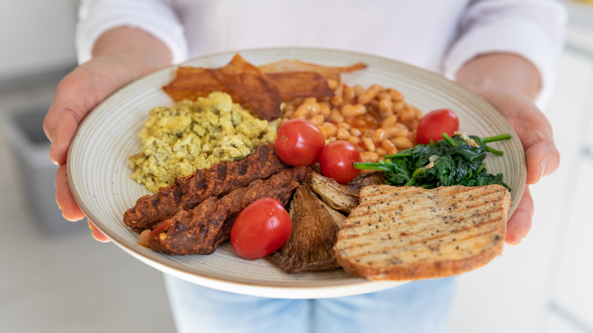 plant based sausages with scrambelled tofu in a cooked breakfast