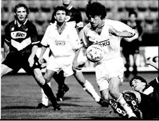 Ivan Zamorano of Real Madrid (2nd R) chases the ball as Lugano player Christian Andreoli (R) falls during their Winners Cup match 29 September 1993, in Zurich, Switzerland. Zamorano scored all three goals in his team's 3-1 victory as Real advances to the next round.