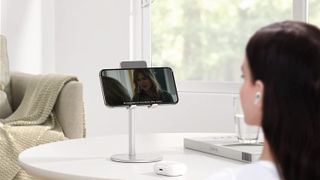 Woman making video call on iPhone placed on Omoton stand