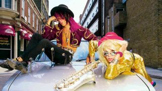 Hanoi Rocks’ Andy McCoy and Michael Monroe posing for a photograph on a car hood