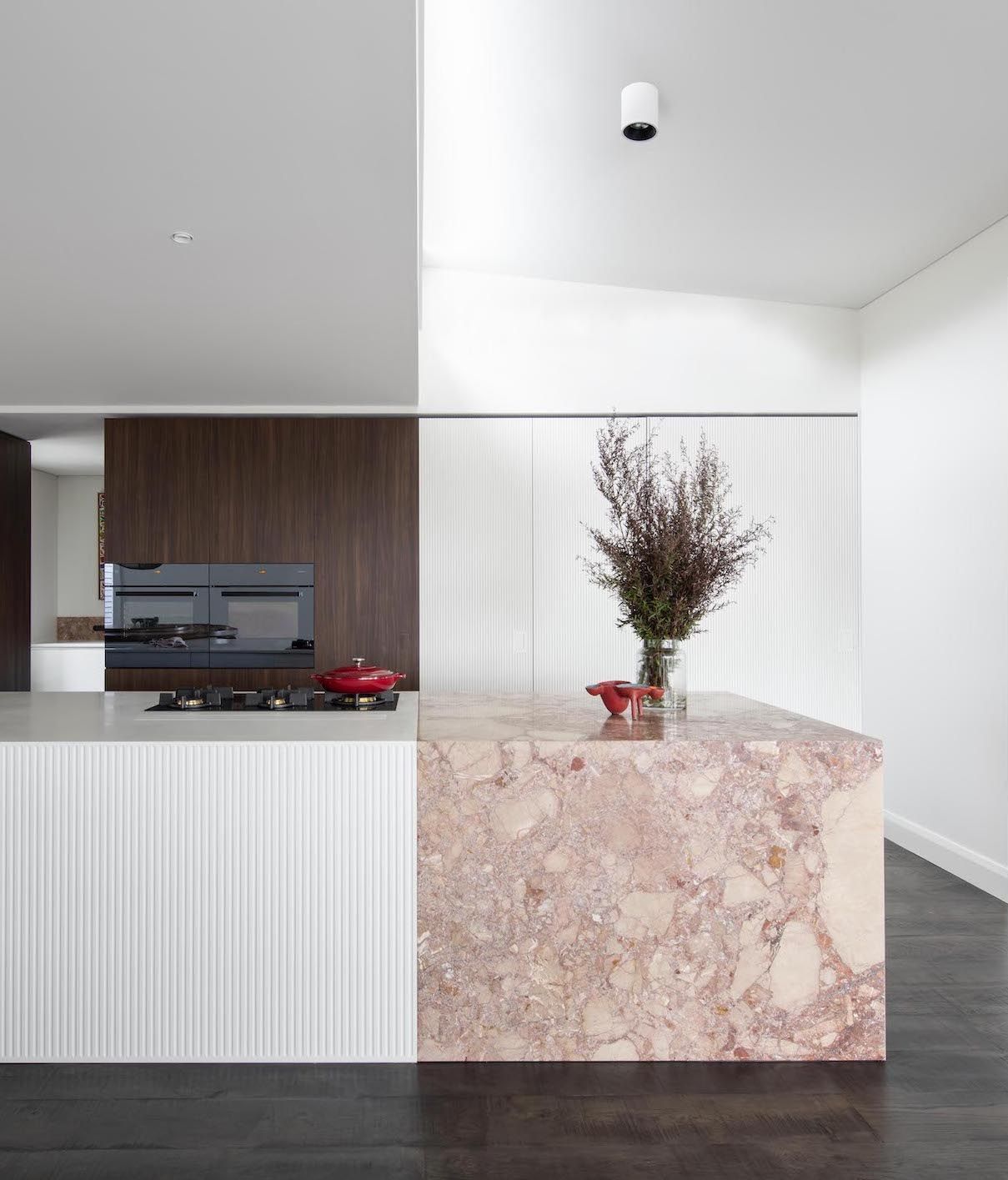 A kitchen with pink marble countertop