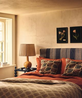 Neutral bedroom, red bedding, flower picture