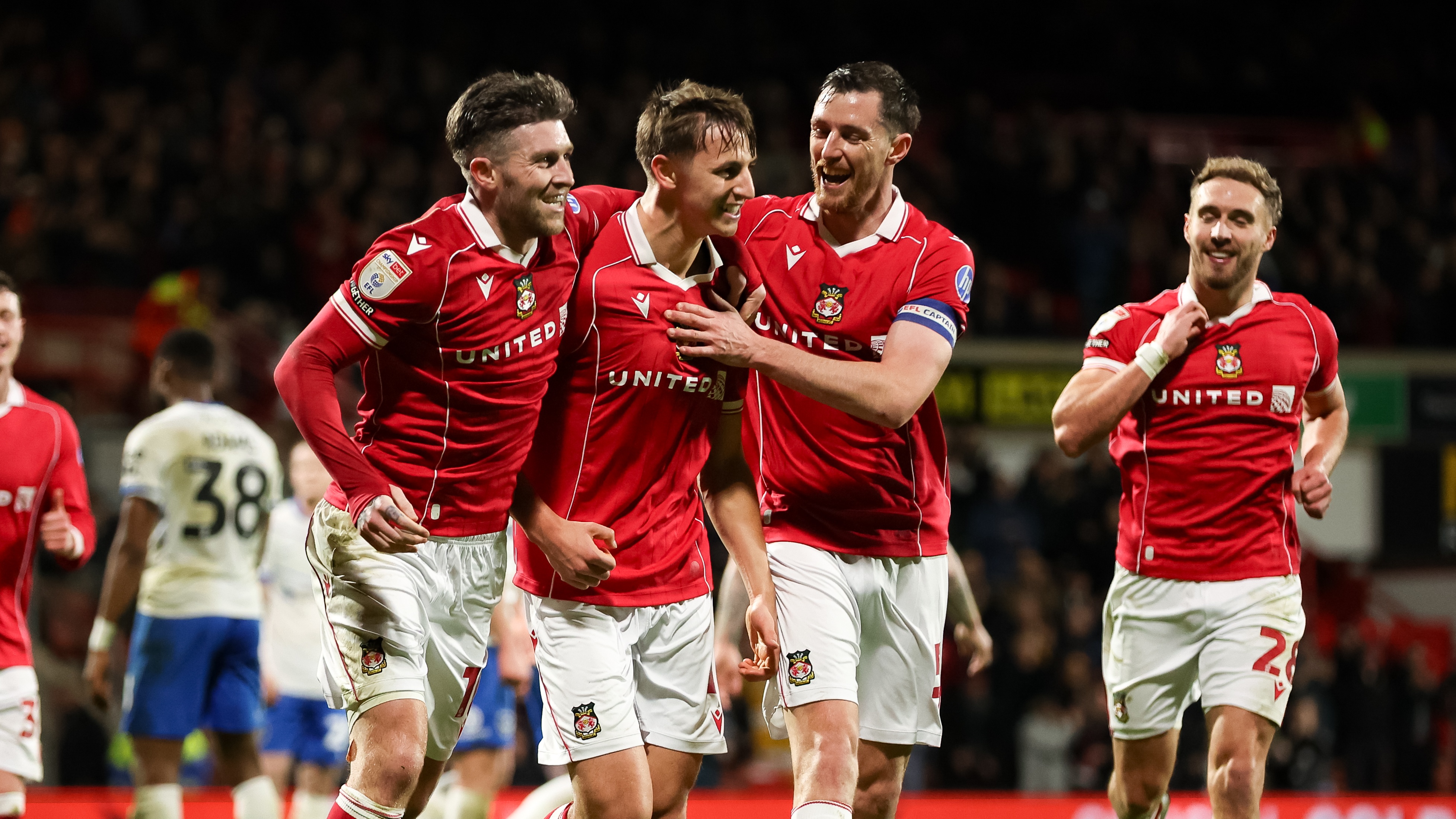 Max Cleworth of Wrexham celebrates with teammates after scoring their team's second goal during the Sky Bet Championship match between Wrexham AFC and Portsmouth at Racecourse Ground on February 24, 2026 in Wrexham, Wales. 