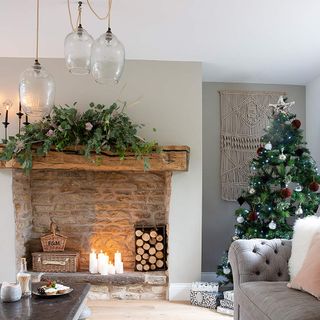 Fireplace with wooden mantelpiece, decorated for Christmas
