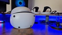 PSVR 2's controllers behind PSVR 2 on a gaming desk