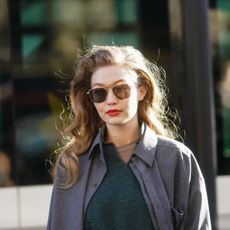 paris, france february 26 gigi hadid wears sunglasses, a gray jacket, a green wool pullover, outside lanvin, during paris fashion week womenswear fallwinter 20202021, on february 26, 2020 in paris, france photo by edward berthelotgetty images