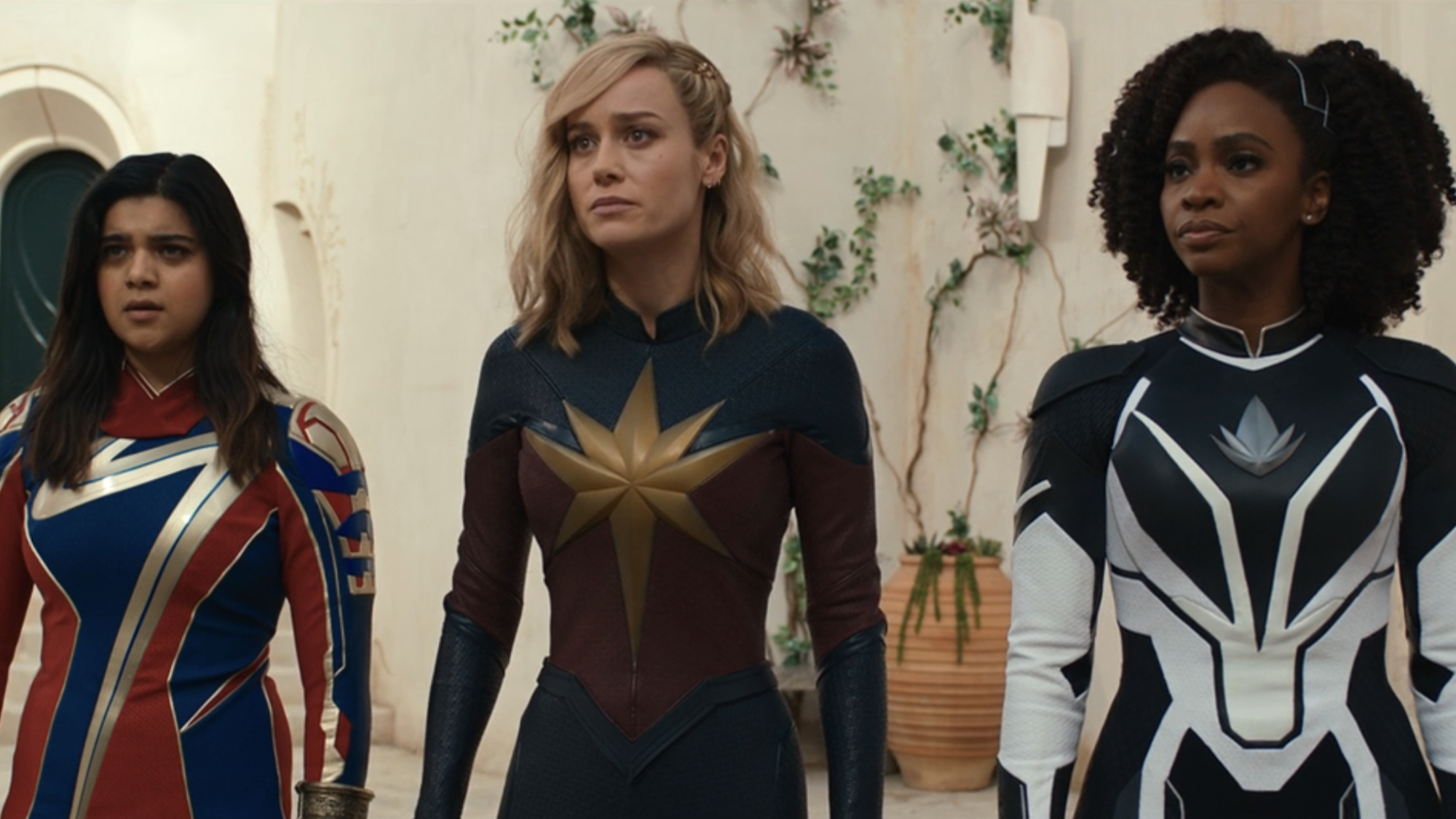 Kamala Khan (Iman Vellani), Carol Danvers (Brie Larson) and Monica Rambeau (Teyonah Parris) stand together in The Marvels.