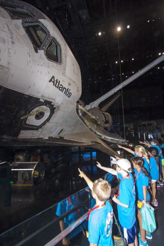 At the Kennedy Space Center Visitor Complex in Florida, Camp Kennedy Space Center participants get an up-close look at the space shuttle Atlantis during a weeklong summer activity for students entering second through ninth grades. Their tour took place just as final preparations were underway for the opening of the "Space Shuttle Atlantis" facility. The exhibit opens on June 29, 2013.