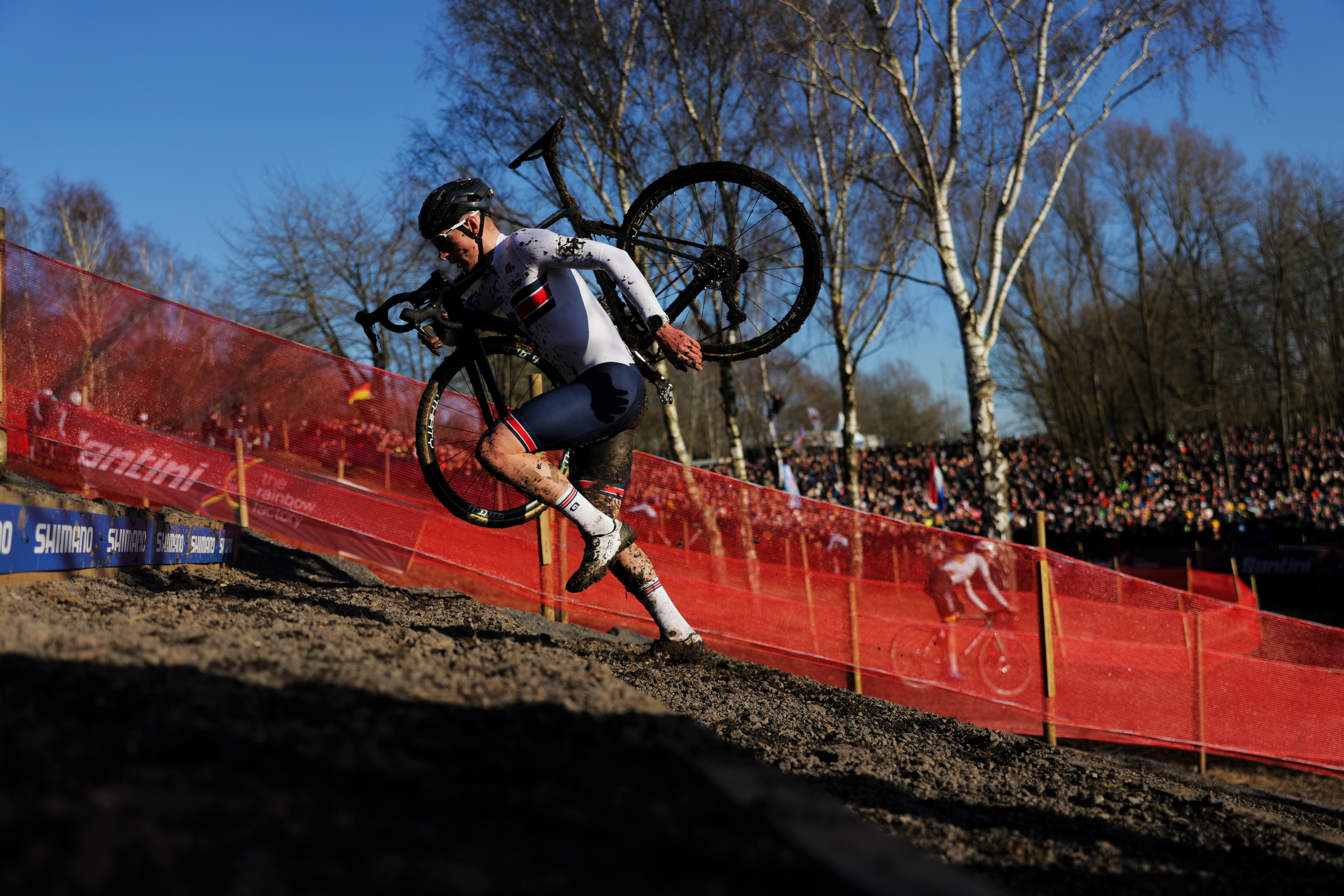 Thomas Mein runs up hill with his bike