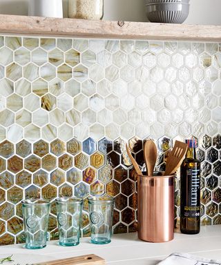kitchen with wooden spatula glasses and mosaic tiles
