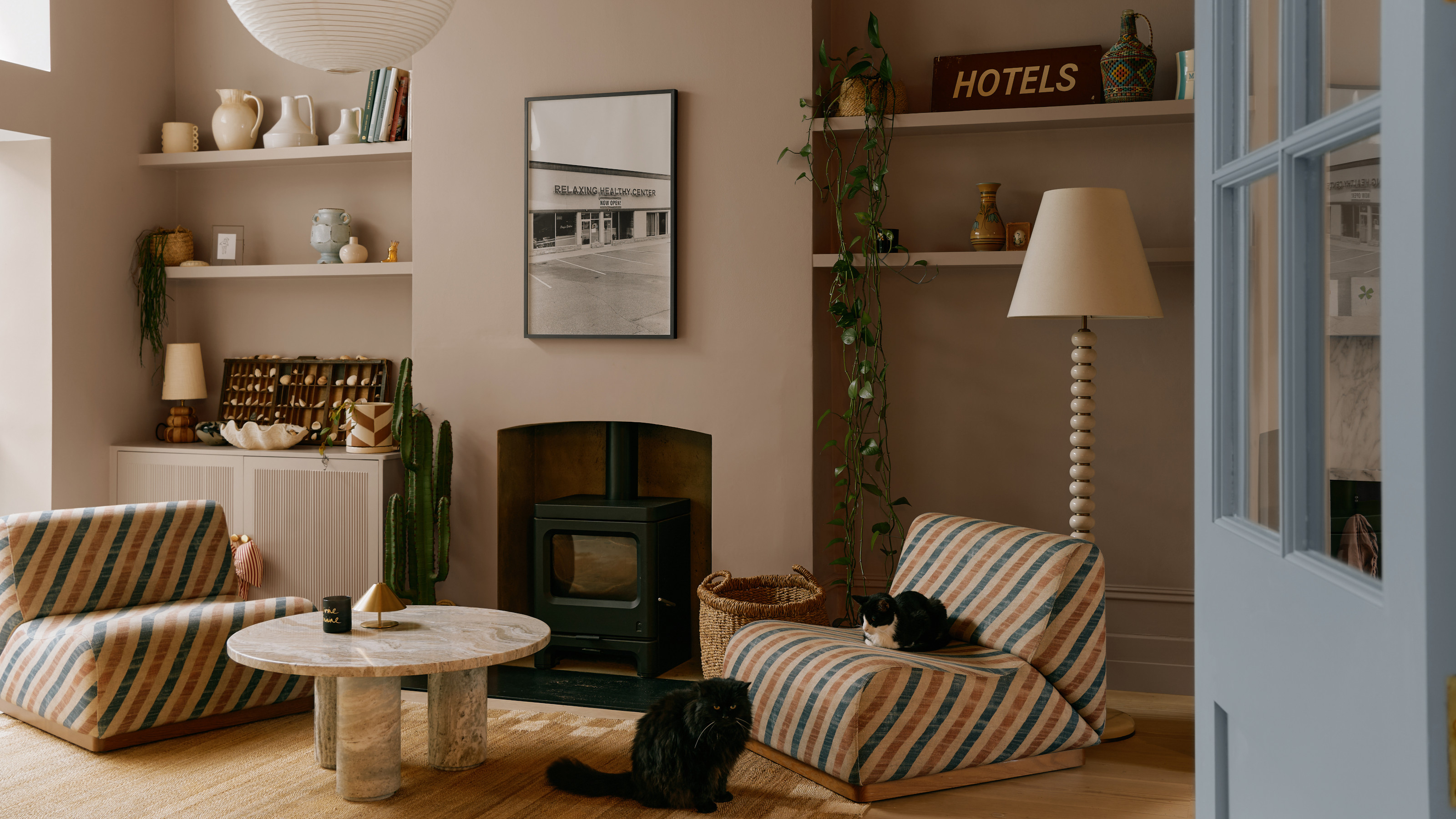 Living room with soft beige walls, striped accent chair and bobbin floor lamp