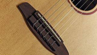 Close up of classical guitar bridge