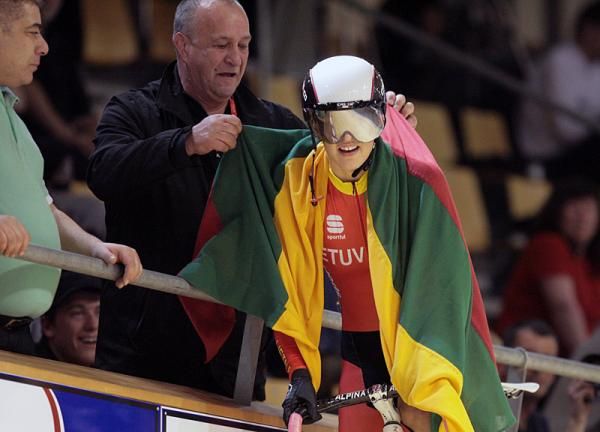 Simona Krupeckaite (Lithuania) goes up to the barrier to get a rather large Lithuania flag.