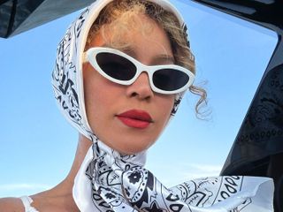 Beyonce wears white cat-eye sunglasses and a white headscarf