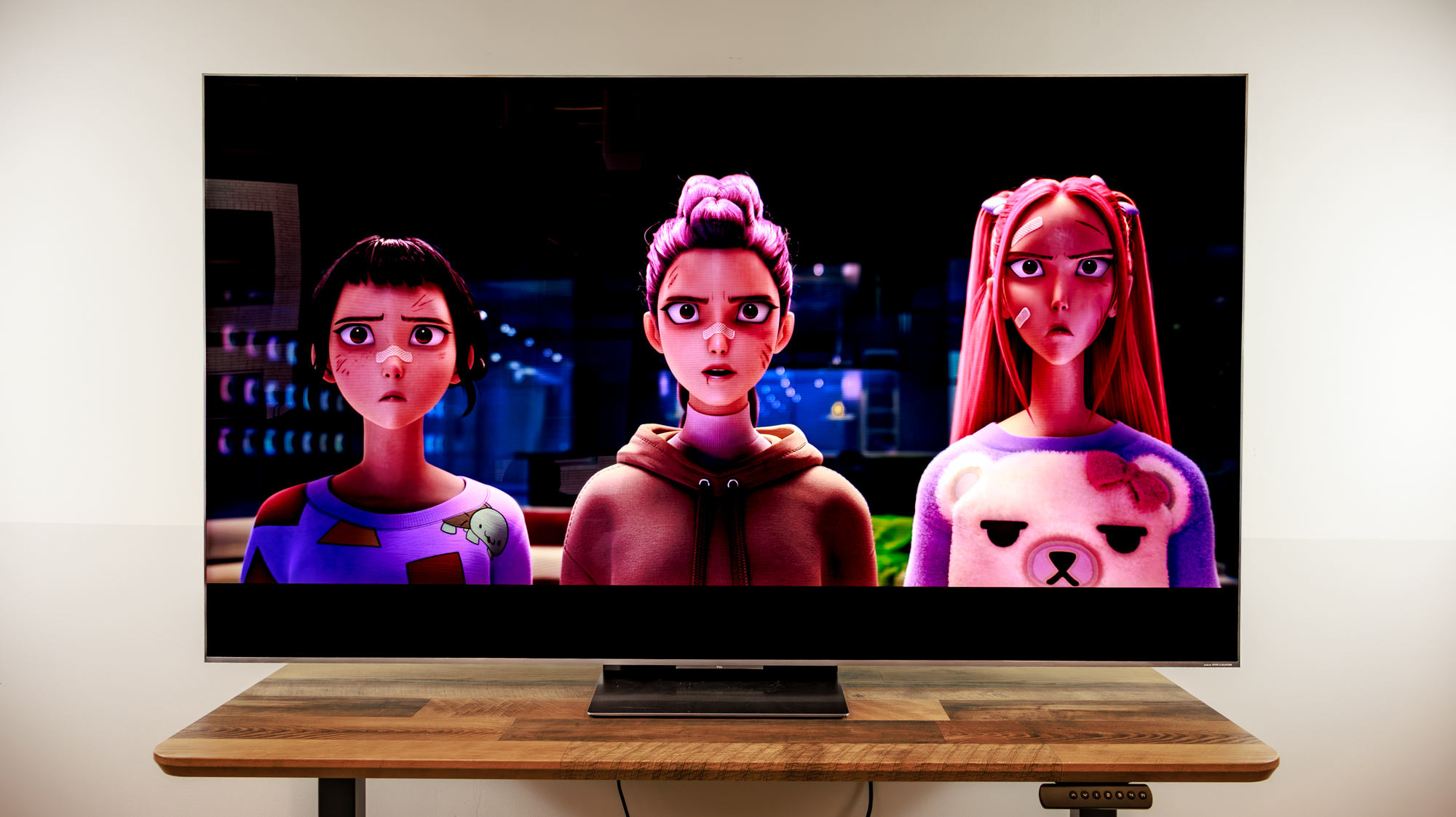 A TCL QM8L TV on a desk