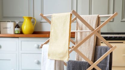 Towels on wooden clothes airer in laundry room