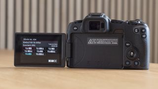 Canon EOS R8 on a table rear view with vari-angle screen flipped out to the side