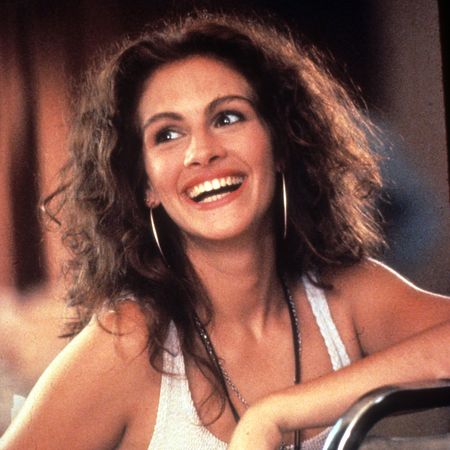 julia roberts as vivian smiling and laughing in a still from pretty woman