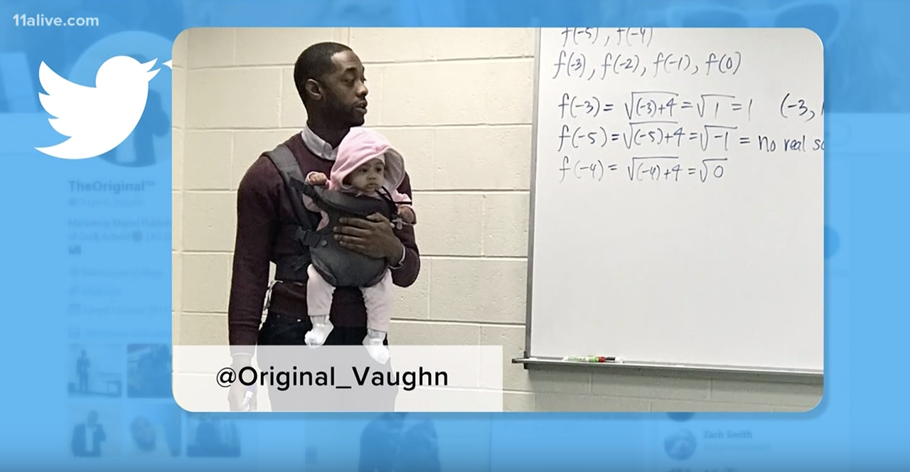 Prof. Nathan Alexander holds his student&amp;#039;s daughter as he teaches.